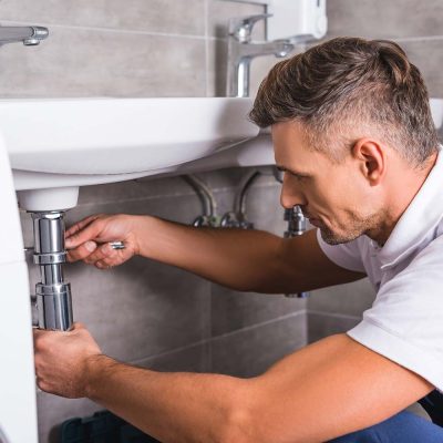 adult-plumber-fixing-sink-at-bathroom-resize.jpg